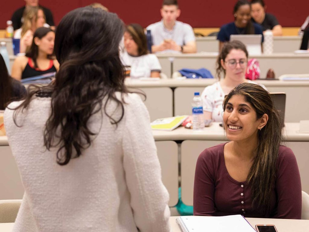 Students in a classroom listen to a speaker