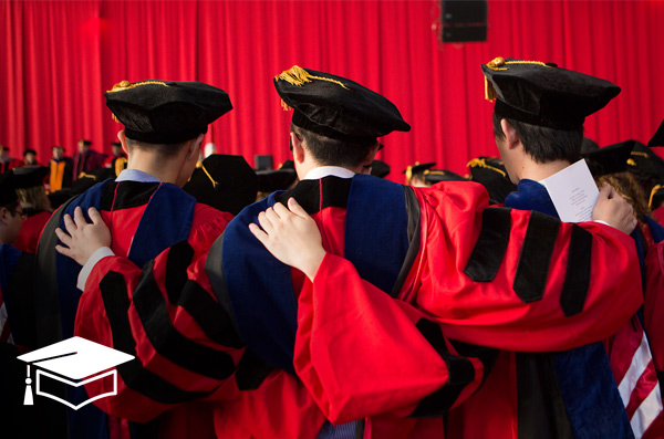 students in cap and gowns at graduation