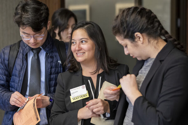 Students in business attire put on name tags.
